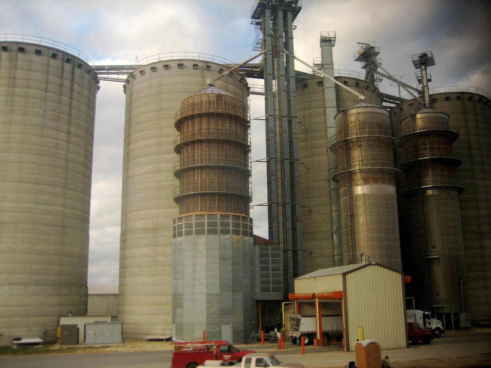 Large industrial silos and processing towers at a plant